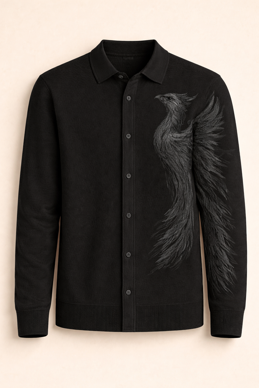 A black flat knit shirt featuring a tonal phoenix embroidery, designed with a full placket and refined structure for elevated everyday wear.